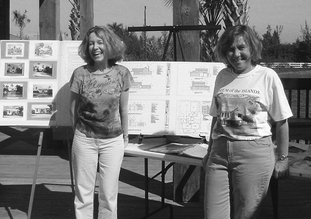 two people stand in front of display tables