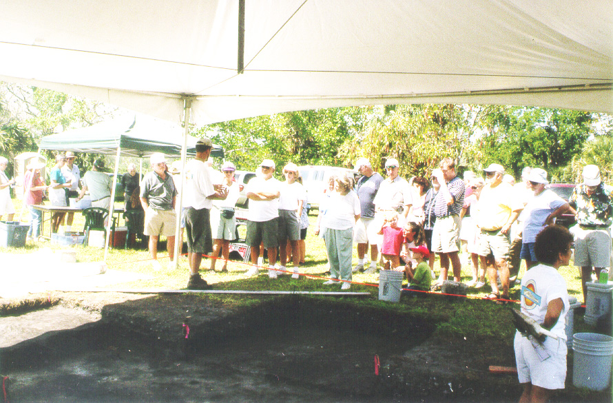 visitors standing around an excavation site during the Calusa Festival.
