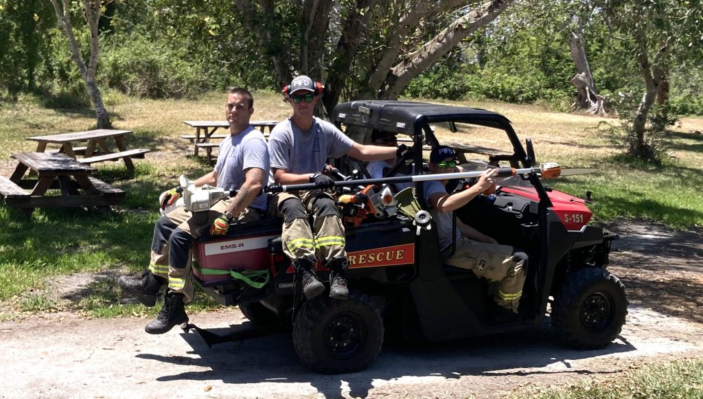 two people sitting on a fire rescue 4-wheeler 