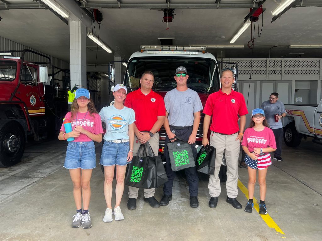 group photo in front of a firetruck