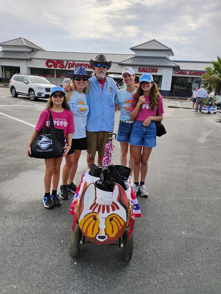 group photo in front of a decorated small wagon