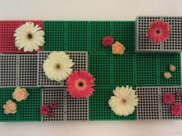 Gerberas and roses arranged on empty pipette boxes