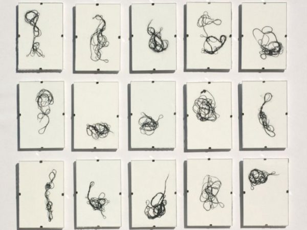 multiple frames of tangled cotton fiber under glass