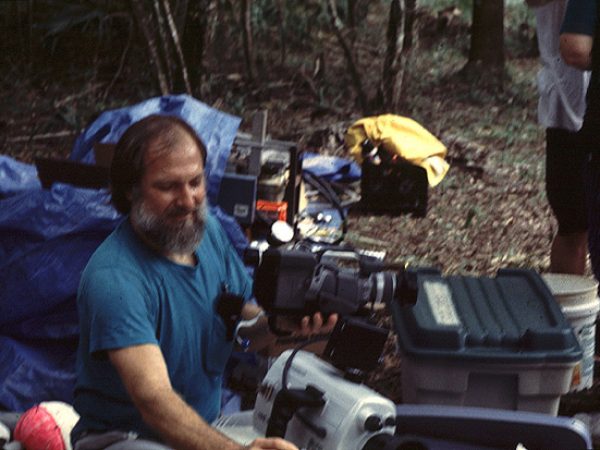 man putting waterproof cover over camera