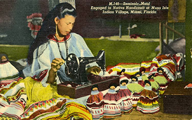 Figure 1: Post card of woman making dolls (2013-6-24). Donated by Anne Reynolds.