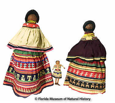 Figure 23: Large Seminole dolls compared to normal sized doll. (2014-12-16/2012-50-32/2014-12-15) 84cm/32cm/70cm. Larger dolls were donated by Reggie, Paula, and Amanda Clauser. Smaller doll was donated by Anne Reynolds.