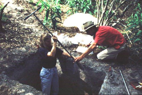 Assisted by Scott Mitchell, Sylvia Scudder takes a soil sample from the Smith Mound, Pineland Site Complex, 1992.