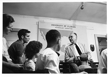 Figure 6: John M. Goggin with anthropology students in University of Florida classroom, examining pottery, circa 1961. Photograph by Flip Schulke, courtesy of the George A. Smathers Library Digital Collections.