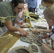 Graduate student Ryan VanDyke shows a young visitor what can be learned from bones and shells, Calusa Heritage Day at Pineland, 2011. (Photo by William Marquardt.)