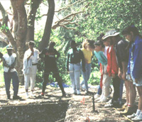 Education coordinator Chuck Blanchard, third from right, explains archaeological research at Pineland to Lee County school students during the “Year of the Indian” project. (Photo by William Marquardt.)