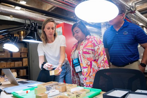 Museum researcher Michelle LeFebvre showing tour participants items in the South Florida Archaeology Collection.