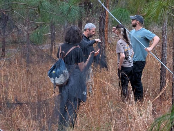 Charlie Muise, UFBO manager, teaches students how to set up mistnets