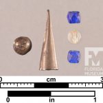 Metal cone object, two blue glass beads and one clear glass bead