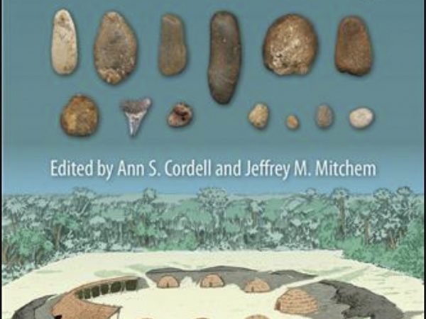 Book cover featuring pictures of stone artifacts and artists reconstruction of a circular village