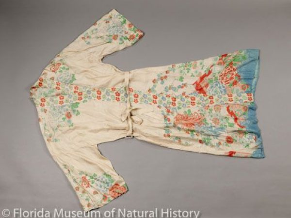 Early 20th century robe composed of tussah silk (Antheraea pernyi) made in Japan. The cloth is natural colored, hand reeled and hand woven. A machine roller printed the floral designs prior to construction of the garment.
