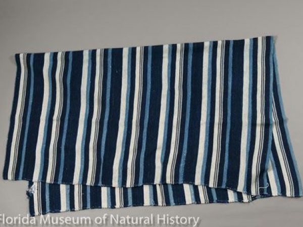 Woman’s Wrapper from Burkina (=Burkina Faso) containing cotton and wild silk (Anaphe sp. or Epanaphe sp., Notodontidae). The blue colors come from indigo dye. Woven in mid twentieth century by a woman of the Marka-Dafing tribe. Measures 115 cm X 136 cm