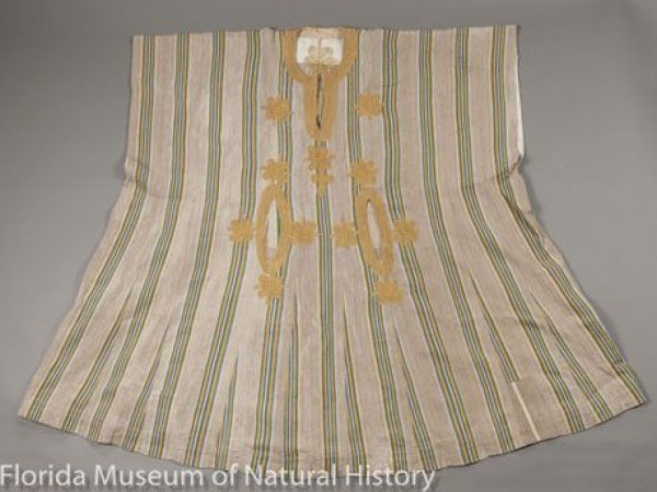 A gbariye (man’s robe) of sanyan silk (Epanaphe or Anaphe, Notodontidae) from Nigeria, Yoruba Tribe. Machine-embroidered with rayon in “endless knot” motif. Such robes normally have matching trousers and cap.