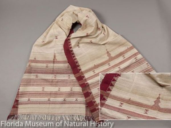 Shawl of tropical tasar silk (Antheraea paphia= A. mylitta) weft and cotton warp, handwoven by a woman of the Dongria Kondha tribe, in the village of Kotpad, in the Koraput District, Odisha. The silk and organic cotton are handspun and natural colored. Maroon portions made from roots and bark of Indian mulberry (Morinda citrifolia). Brocaded with interlocking temple designs.