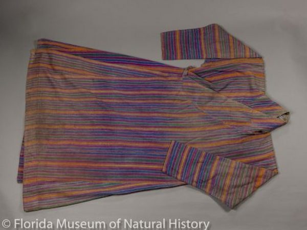 A gho (man’s robe) handwoven in western Bhutan, mainly of eri silk (Samia ricini). The side panels are probably cotton, as is the heavy inner lining. It has bands of yellow, blue, green, and red, in a adha mathra pattern, colored with natural dyes (indigo, madder, turmeric). It was stated to be more than 100 years old when purchased in 2009.