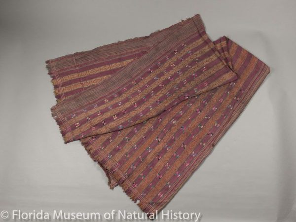 A kira (woman’s dress) handwoven entirely of eri silk (Samia ricini). It is more than 100 years old, and was woven by Aum Dawa Dem, who was from Minjey Gewog, in the Kurto region of Lhuntshi District of central Bhutan. She was an official master weaver for royal families. This kira belonged to Chusa Ahi Ugyen, of a wealthy, noble family in far eastern Bhutan. This mentsi mathra design in supplementary warp pattern (aikapur) is no longer woven. Measures 122 cm X 216 cm