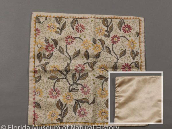 Front of pillowcase is Chinese tussah (Antheraea pernyi), with kantha style embroidery by hand. Backside is satin silk. Made in Kutch district in the state of Gujarat, India. Chinese tussah is commonly imported into India. Measures 40 cm X 40 cm