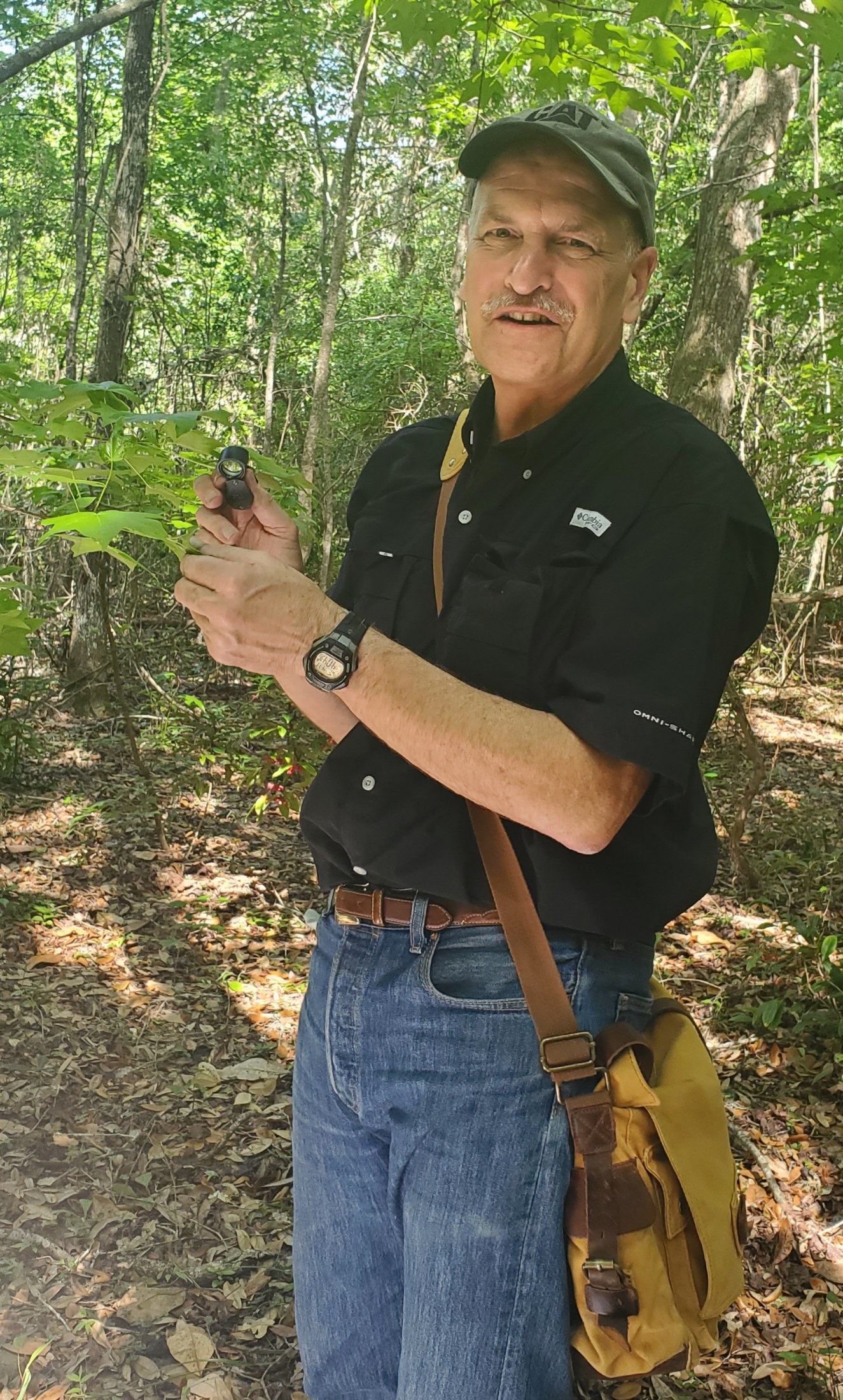 Man standing in woods.