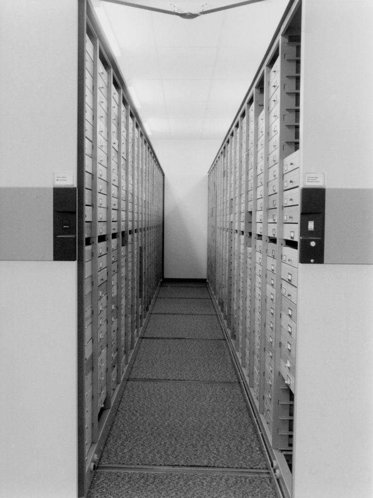 An aisle showing columns of insect display drawers.
