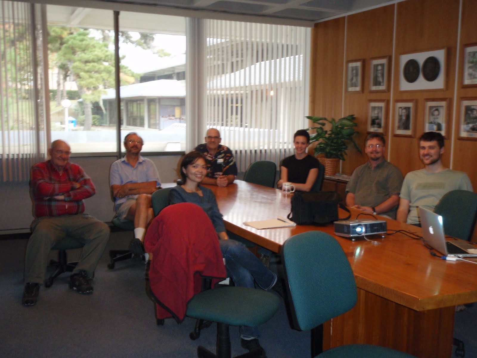 IZ group sitting around the table in the conference room