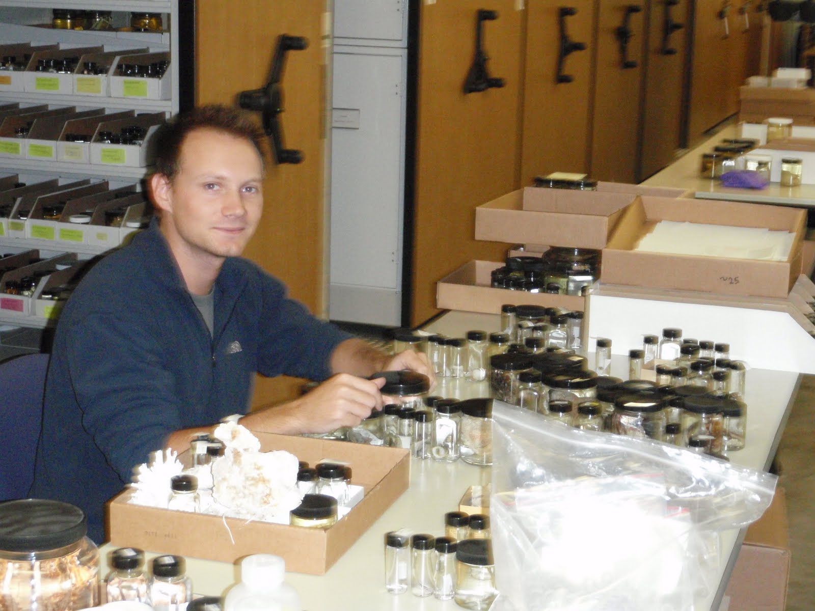 Derek sitting with a pile of jars
