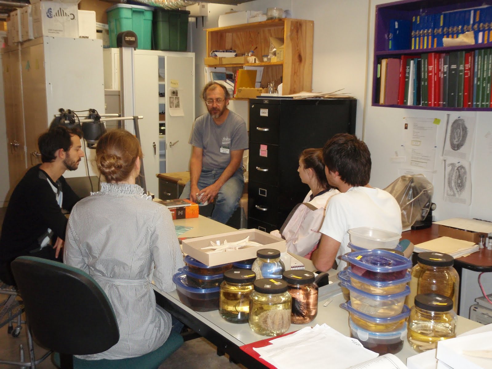 Gustav, François, Julie, JD, and Laura meeting around a desk