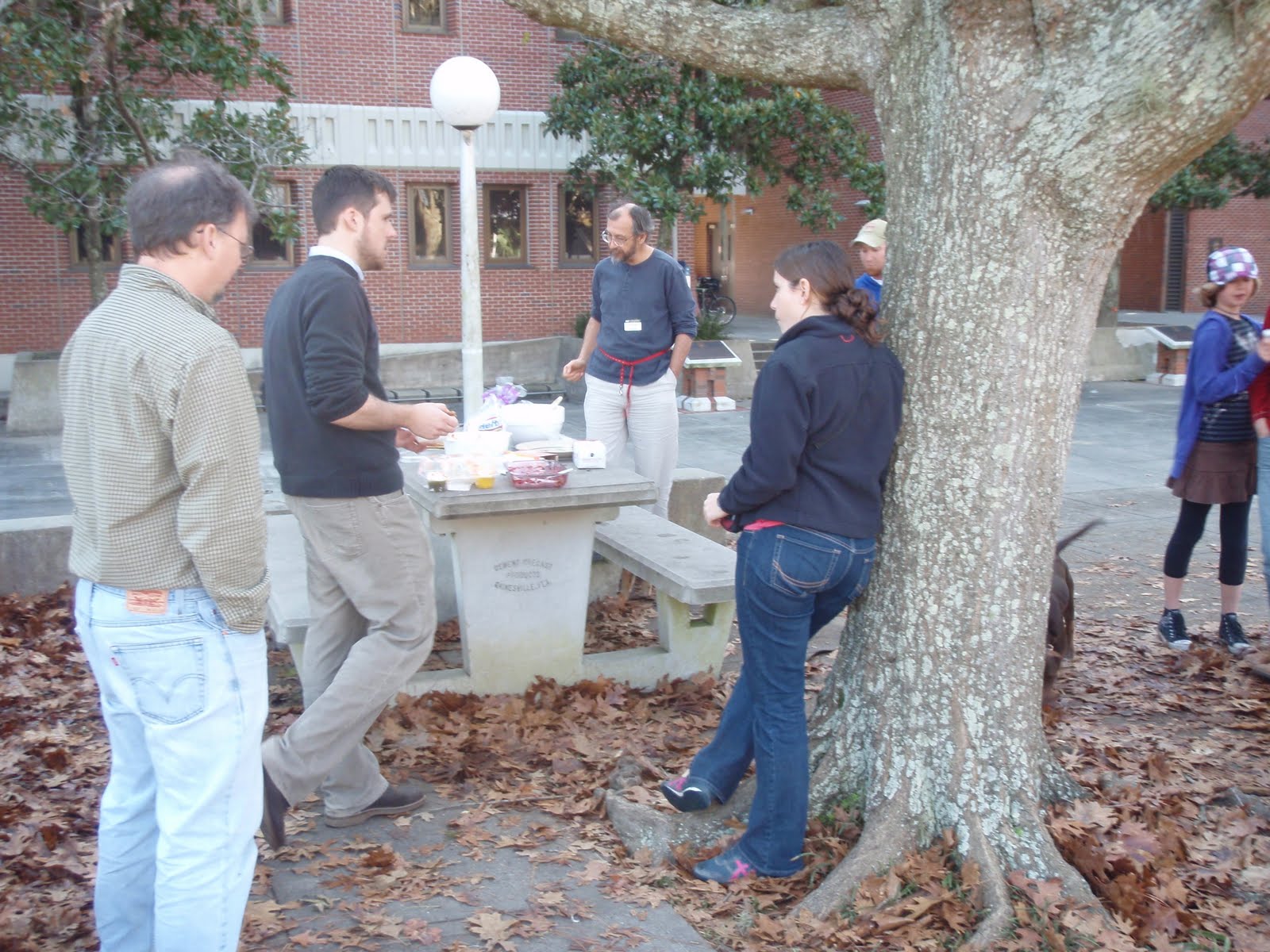 IZ crew at the picnic tables outside Dickinson Hall. Visible puppy tail