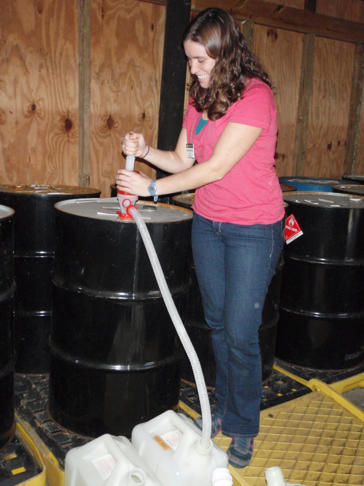 Sarah pumping ethanol out of a 55 gallon drum of ethanol