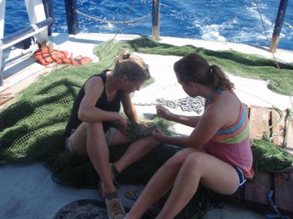 Julie and Christine on the deck repairing a net