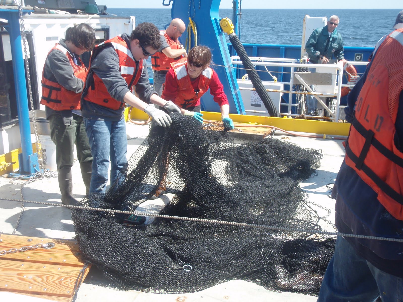 Jenna and Mandy combing through the trawl net on deck