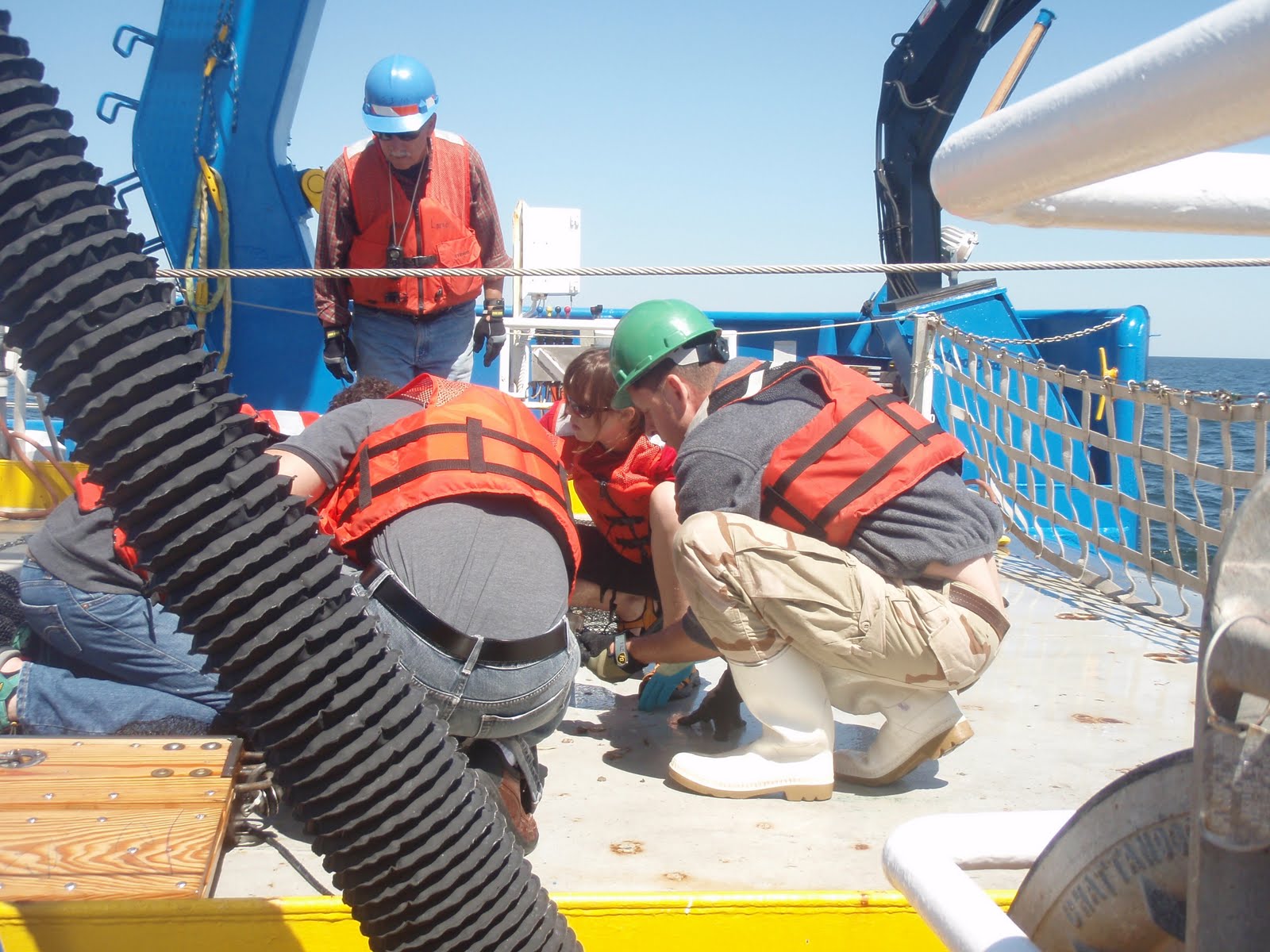 group crouched around the net on deck