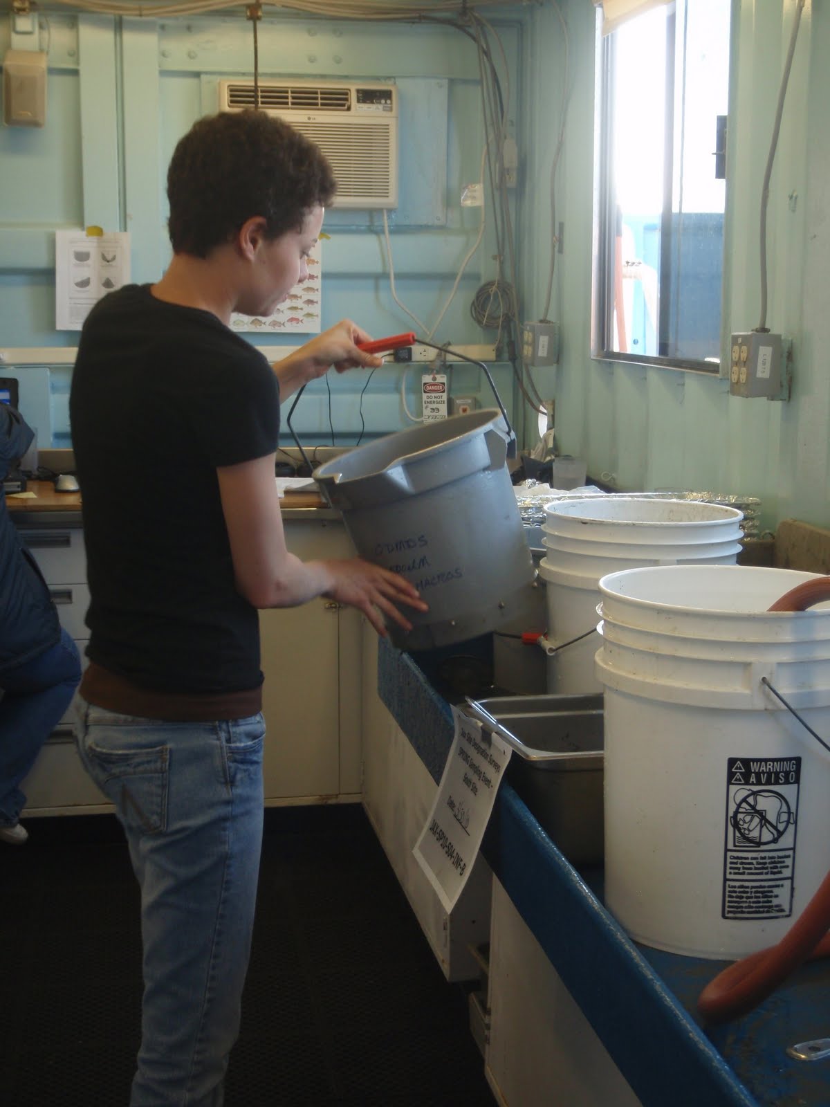 jenna using a bucket seive