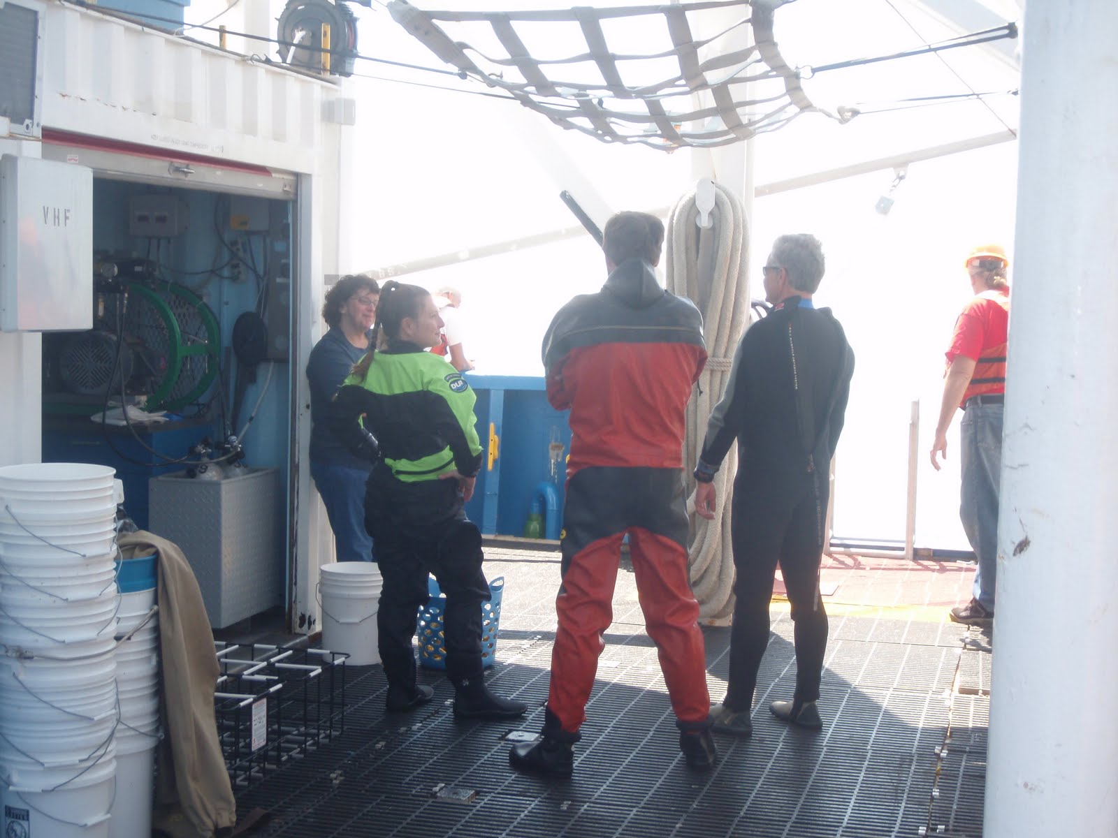 divers and some crew conversing on deck