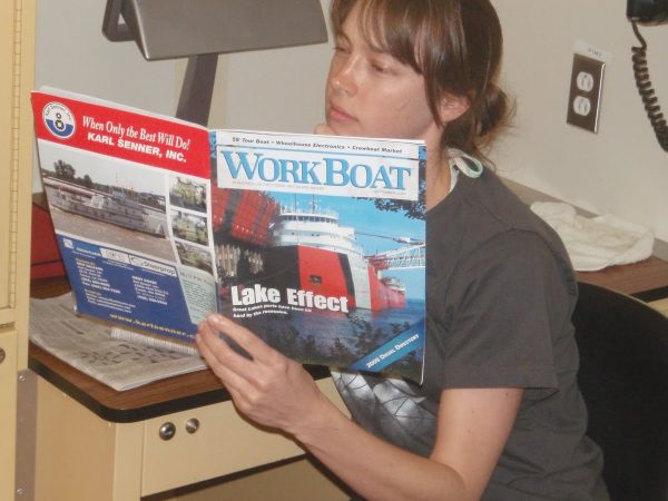 Mandy perusing WorkBoat at the desk in the bedroom