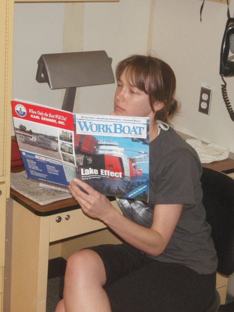 Mandy perusing WorkBoat at the desk in the bedroom