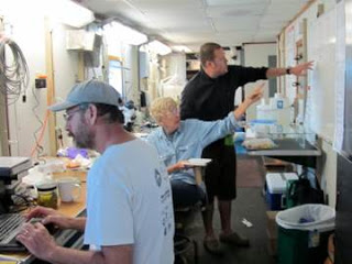 Judy, Brendan, and Gustav in the lab space on the boat