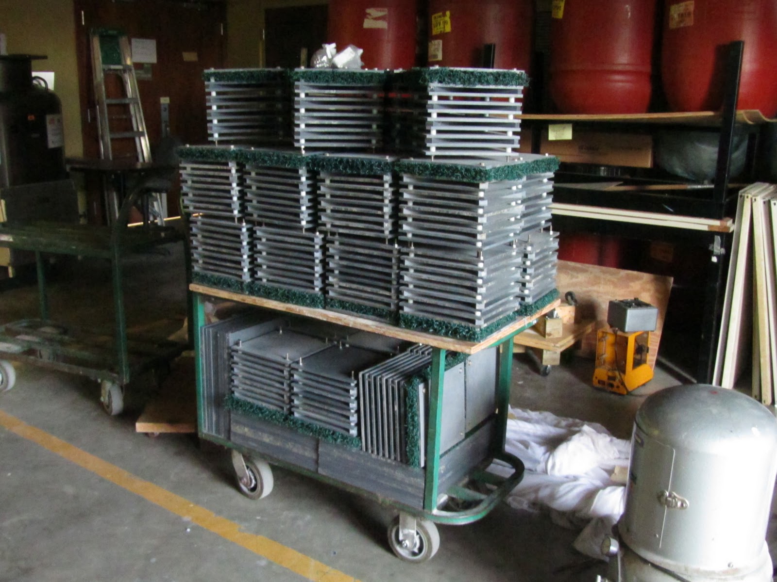double-decker cart piled to the max with partially assembled ARMS