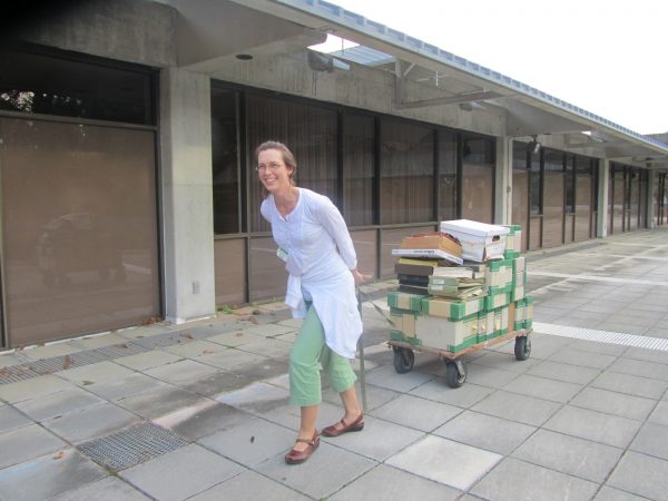 mandy hauling a cart piled with boxes outside Dickinson Hall