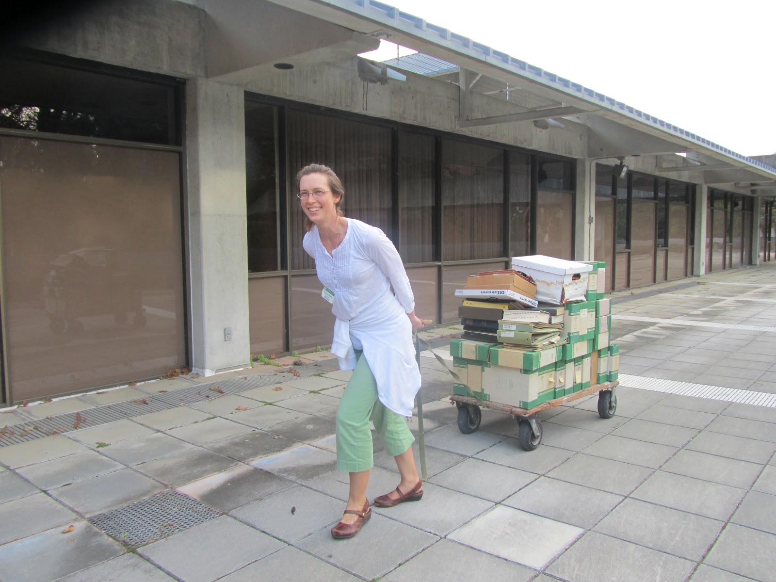 mandy hauling a cart piled with boxes outside Dickinson Hall