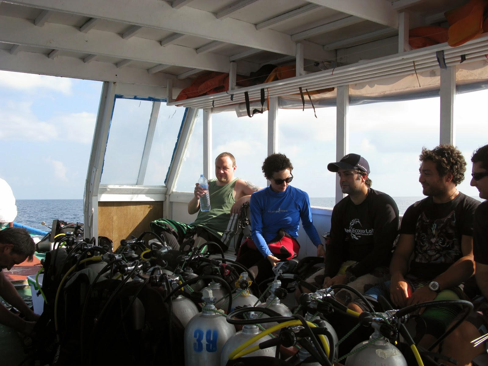 interior of boat crowded with researchers and SCUBA gear