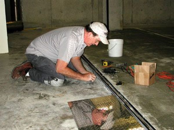 man prepping the floor in collection room
