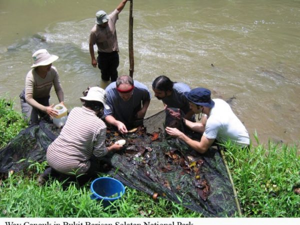 people on Indonesian river bank