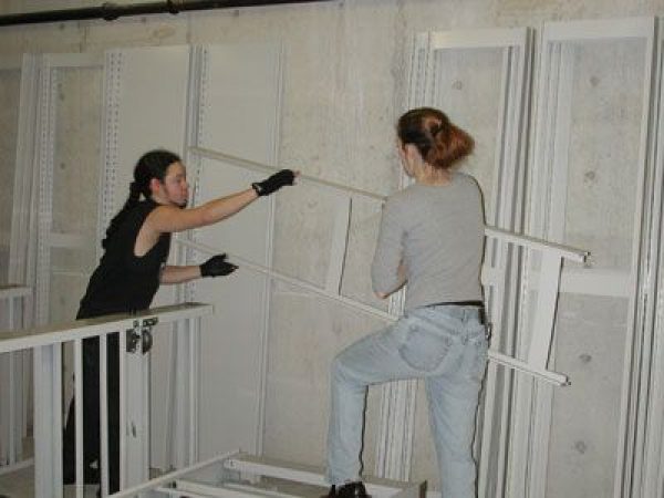women setting up collection shelves