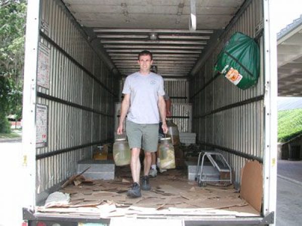 man in back of box truck