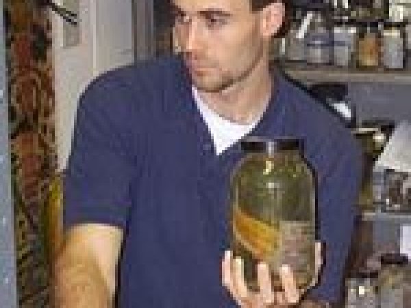 man holding jarred specimen