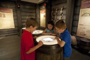 Students observe artifacts explaining how Native Americans made jewelry and other items out of silver and gold from shipwrecks off Florida’s coasts in the "First Colony: Our Spanish Origins" exhibit. Florida Museum of Natural History photo by Kristen Grace 